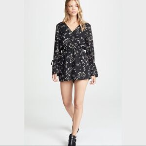 Cupcakes and Cashmere Black Floral Romper. Size Medium. New With Tags. NWT.